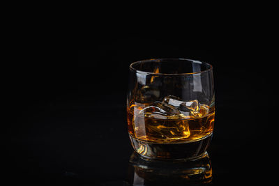 Close-up of drinking glass against black background