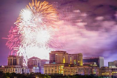 Firework display over city at night