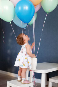 Rear view of girl with balloons