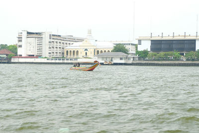 Boat in river against clear sky