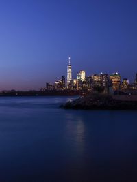 Illuminated city at waterfront