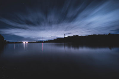 Scenic view of lake against sky at night