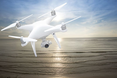 Airplane flying over sea against sky