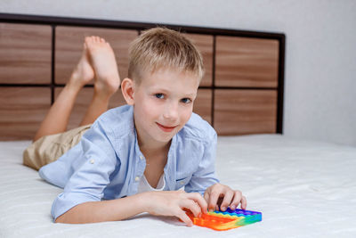 Portrait of boy sitting on sofa