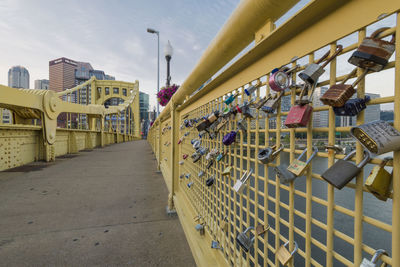 Locks on railing of bridge in city