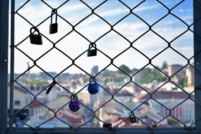 Close-up of chainlink fence against sky