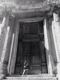 Statue of woman in front of historic building