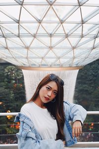 Portrait of young woman sitting outdoors