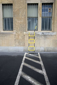 Road sign on street by building