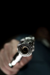 Close-up of human hand against black background