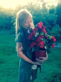 Full length portrait of woman standing on field