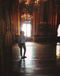 Full length of woman standing in building