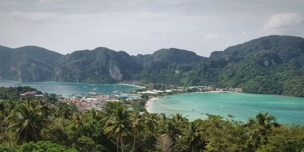 Scenic view of sea and mountains against sky