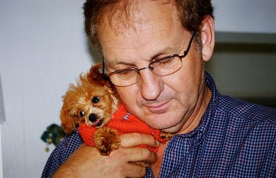 Man with puppy at home