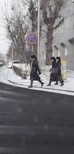 People walking on road in city