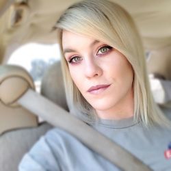 Portrait of beautiful woman sitting in car