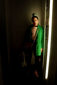 Portrait of young man standing at home