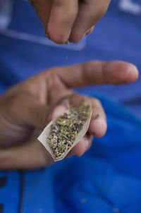 Close-up of hand holding cigarette