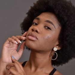 Close-up portrait of young woman holding hands