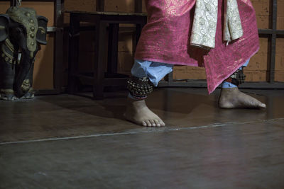 Low section of woman standing on floor at home