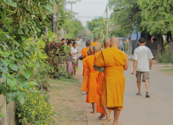 Rear view of people walking in temple