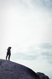 Silhouette of couple on rock