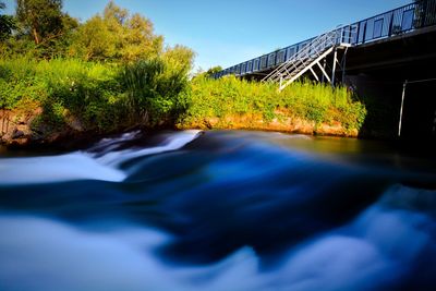 Scenic view of bridge over river against sky