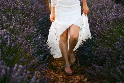 Low section of woman standing on field