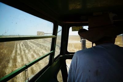 Man seen through car windshield