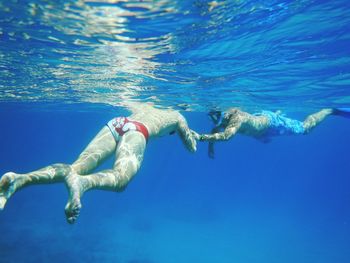 Male friends swimming in sea