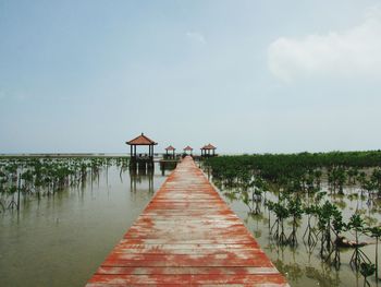 Pier over lake against sky