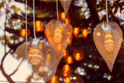 Low angle view of illuminated lanterns hanging on tree