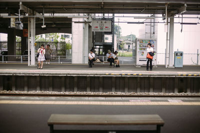 People waiting at railroad station platform