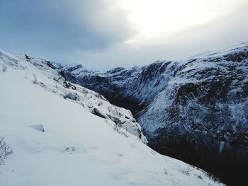 Scenic view of snow covered mountains against sky