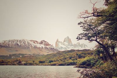 Scenic view of lake and mountains against sky