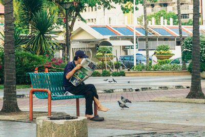 Man sitting on bench in park