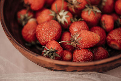 High angle view of strawberries in basket on table