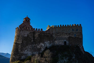 Low angle view of historic building against blue sky