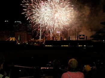 Firework display in city at night