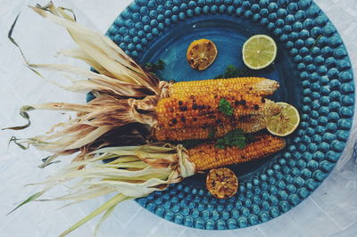 Directly above shot of sweetcorns in plate on table