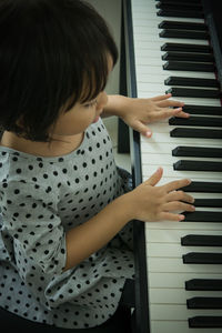 Close-up of girl playing piano