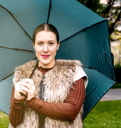Portrait of a young woman with an umbrella, concept of well-being, protection