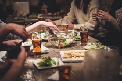 Friends having food and drink in restaurant