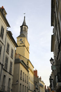 Low angle view of buildings against sky in city