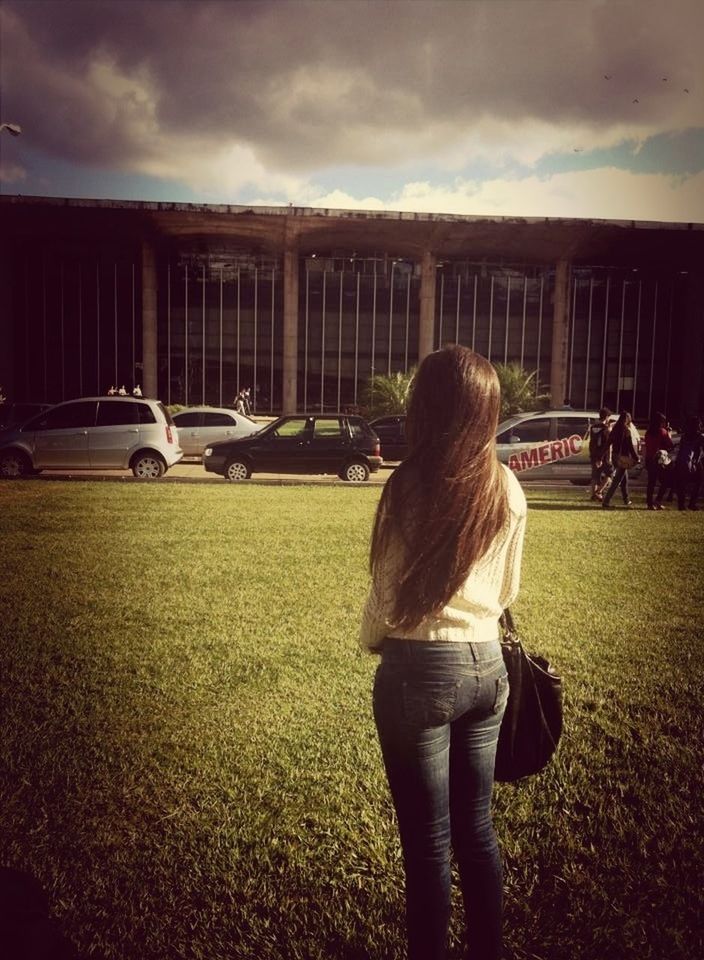 lifestyles, rear view, leisure activity, sky, person, standing, grass, field, cloud - sky, casual clothing, full length, building exterior, built structure, walking, men, long hair, architecture, girls