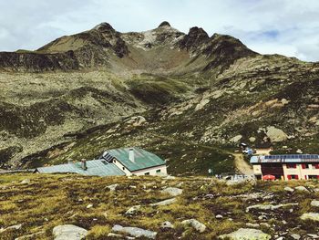 Scenic view of field and mountains against sky