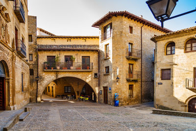 Street amidst buildings in town against sky