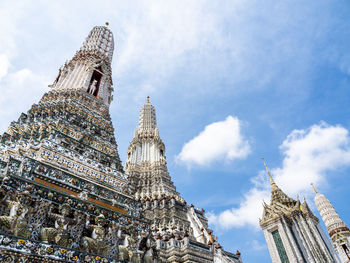 Spires of the wat arun temple, temple of dawn, in bangkok, thailand, stretching towards the sky.