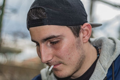 Close-up portrait of young man looking away