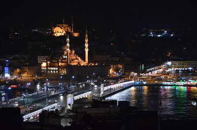 Illuminated yeni cami mosque and galata bridge seen from galata tower at night